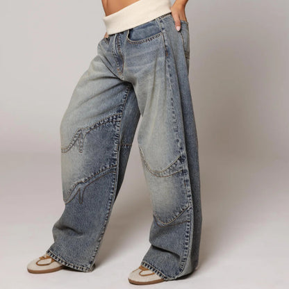 Wide-leg jeans worn by a person on a plain background