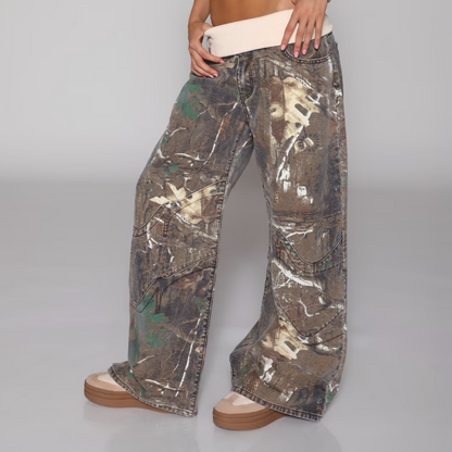 Camouflage pants worn by a person on a gray background