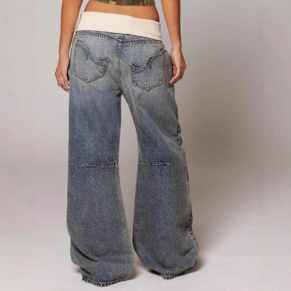 Wide-leg jeans worn by a person on a plain background