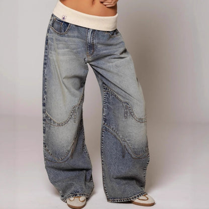Wide-leg jeans worn by a person on a plain background